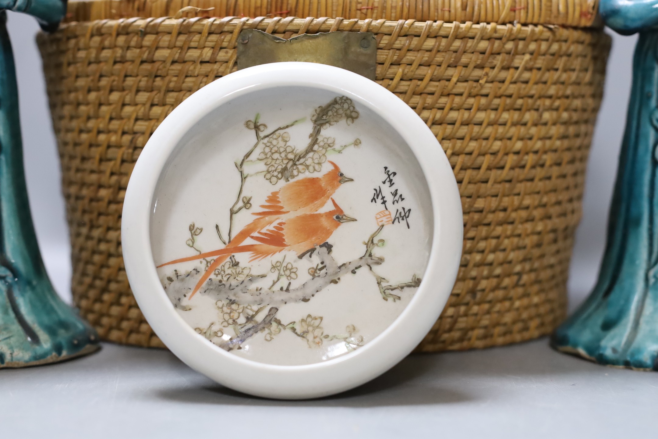 A Chinese teapot and two tea bowls in carrying basket, two Chinese blue figures, and a Chinese enamelled porcelain brush washer, 9.5cm diameter (5)